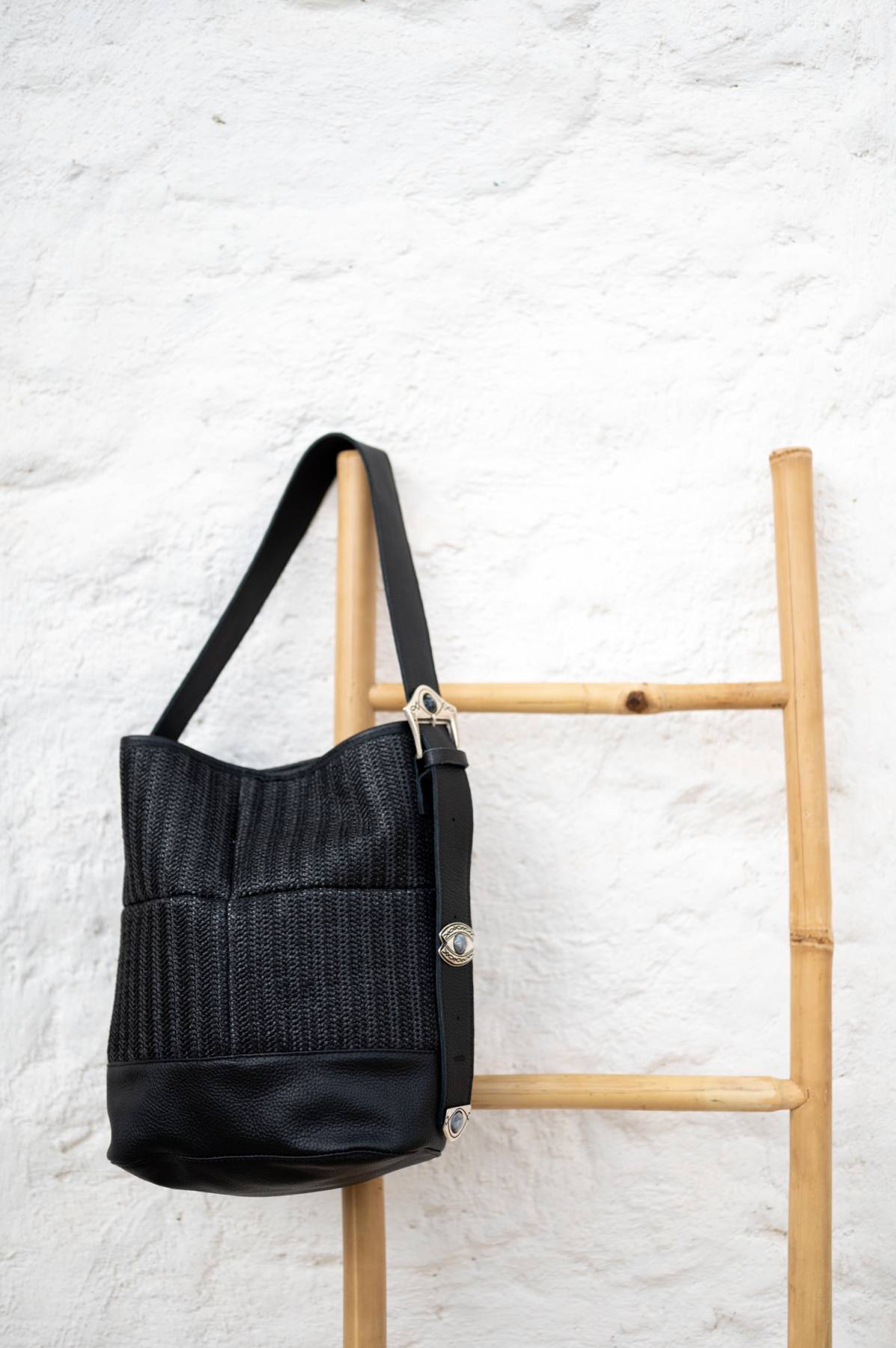 Bucket bag in black leather & straw